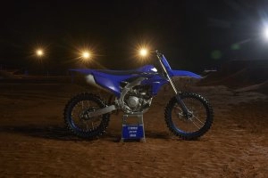 YZ450F Team Yamaha Blue on stand under stadium lights}